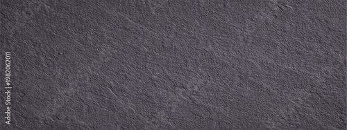 Abstract a close-up texture showcases the rugged beauty of a gray stone surface, revealing intricate details and a timeless aesthetic.