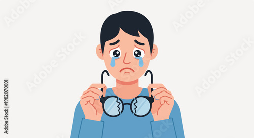 A sad young person crying while holding a pair of broken eyeglasses in their hands