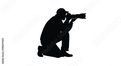 Silhouette of a photographer kneeling while operating a large camera
