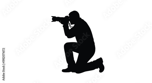 Silhouette of a photographer kneeling while taking a picture
