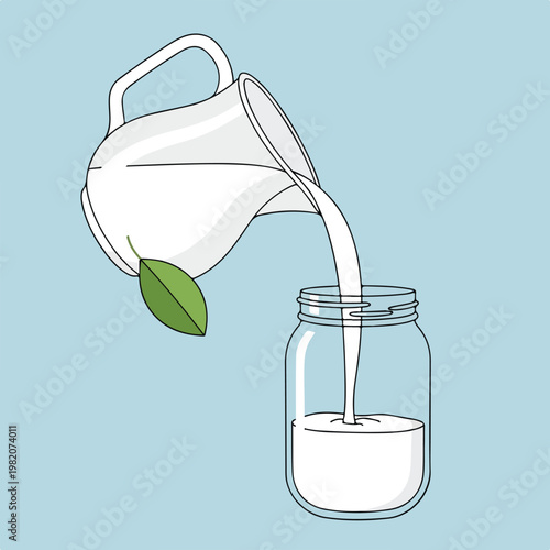 White liquid pouring from a ceramic pitcher into a glass jar with a green leaf