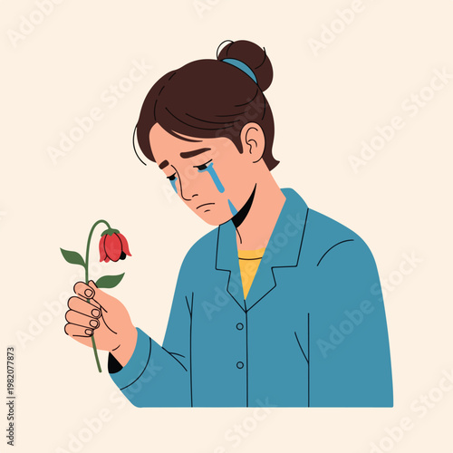 A sad woman with tears crying while holding a drooping red flower in her hand