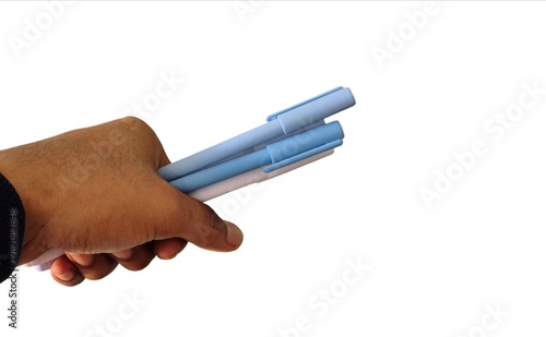 Hand holding three light blue pens isolated on white background showing grip and everyday use
