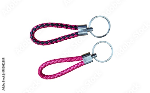 Two braided leather keychains in pink and black colors with metal rings isolated on white background