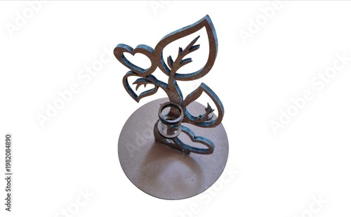 Decorative metal leaf sculpture with abstract floral design on round base isolated background