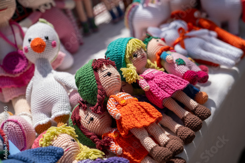 Handmade Colorful Amigurumi Dolls Displayed at Market Stall