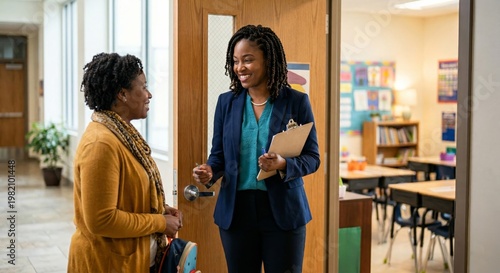 Teacher warmly greets parent at classroom door for a positive school conference, fostering communication