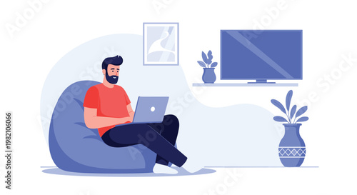 Young man relaxes in a comfortable blue bean bag chair while working on his laptop in a minimalist home living room with a television.