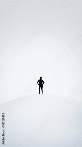 Contemplative figure standing alone on snowy hill open landscape minimalist photography serene environment wide angle view