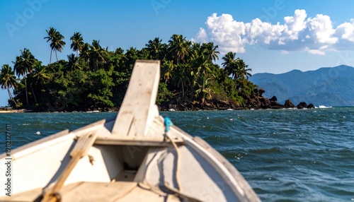 Boat's view of a tropical island, lush vegetation, sunny day, blue ocean