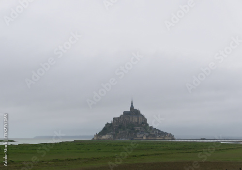 Mount Saint Michel in the distance on a cold and rainy day