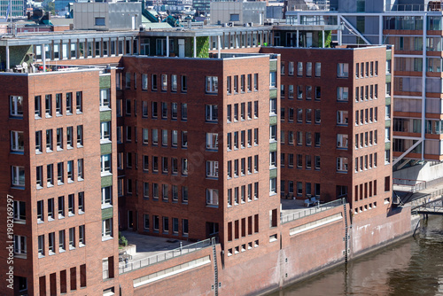 Modern red brick residential and office buildings on the waterfront of a canal in Hafencity district, Hamburg