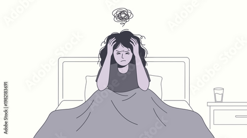 Stressed female office manager sitting on bed holding her head with exhaustion, concept for mental health awareness, professional burnout and sleep disorder education