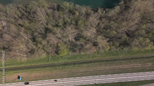 Top-down aerial reveal of floating solar farm on a lake besides a sand quarry