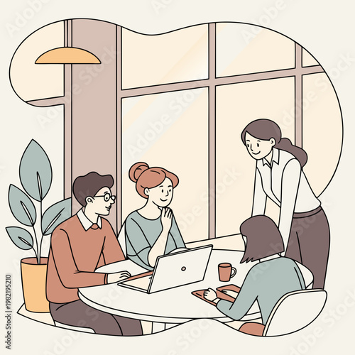 Four people working together at a table with a laptop