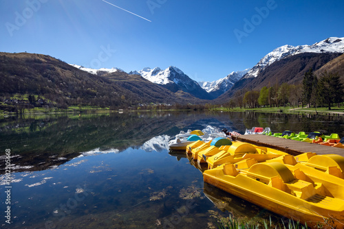 Fotografie Pedal boats on the jetty of Lake Génos Loudenvielle, France, with the Pyrenees m