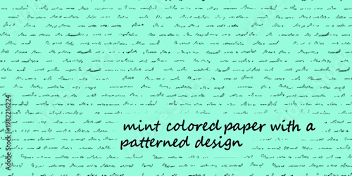 A full frame of vintage handwriting on a mint green background