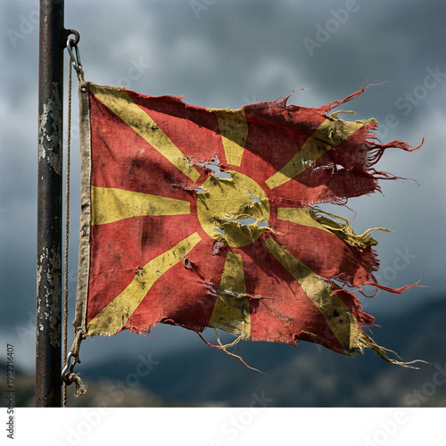 Obraz na plátne Tattered macedonian flag waving against a stormy sky with north macedonia tatter