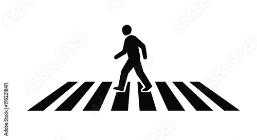 Silhouette of a person walking across a pedestrian crosswalk