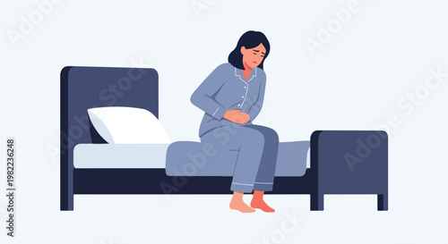Distressed woman sitting on her bed holding her stomach in pain wearing pajamas