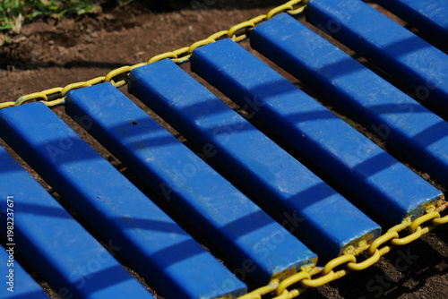 Blue steel bridge in a children's playground.