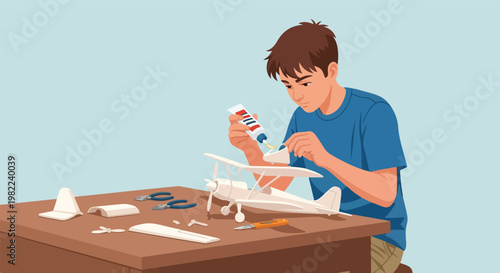 Teen meticulously assembling a white model biplane using glue at a wooden table