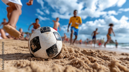 Beach soccer players gathering around a deflated ball on the sand, immersing themselves in invigorating outdoor recreation with a backdrop of the ocean