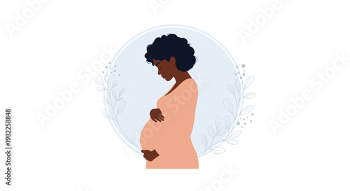 Silhouette of a pregnant African American woman in a peach dress standing inside a circular frame decorated with delicate leaf branches.