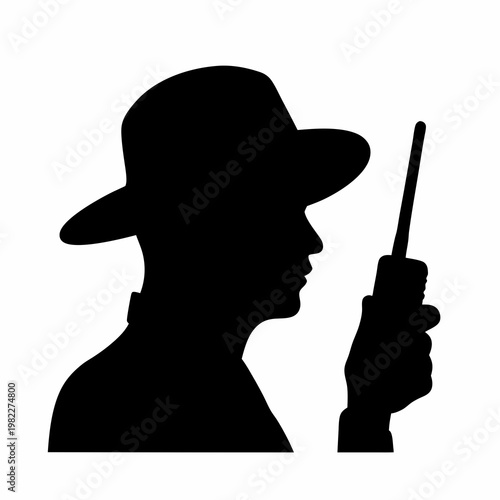 Silhouette of a person with a hat holding a walkie talkie