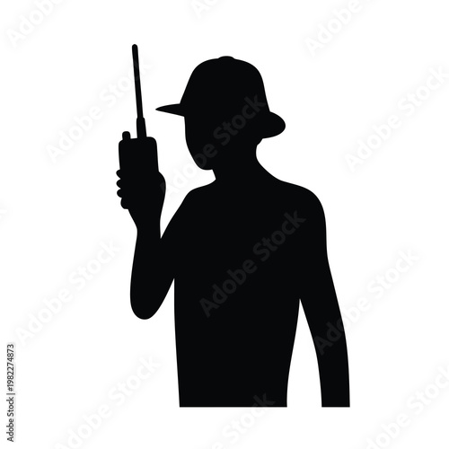 Silhouette of a person in a hat communicating via a walkietalkie device