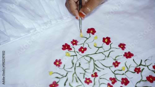 Young girl painting colorful floral patterns on white fabric for Pohela Boishakh festival, expressing child creativity, traditional Bengali culture, art education, and festive celebration. Drawing