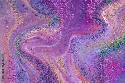 abstract colorful purple background with liquid paint on water with glitter, luxurious wallpaper with paint swirls and shiny glitter 