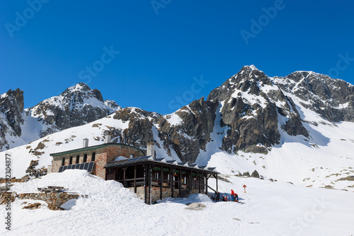 Teryho chata, Mala Studena dolina, Vysoke Tatry, High Tatras, Slovakia. Mountain cabin and hut in the winter. Rocky mountains, peak and summit. Landscape with building. Sunny, snow and blue sky