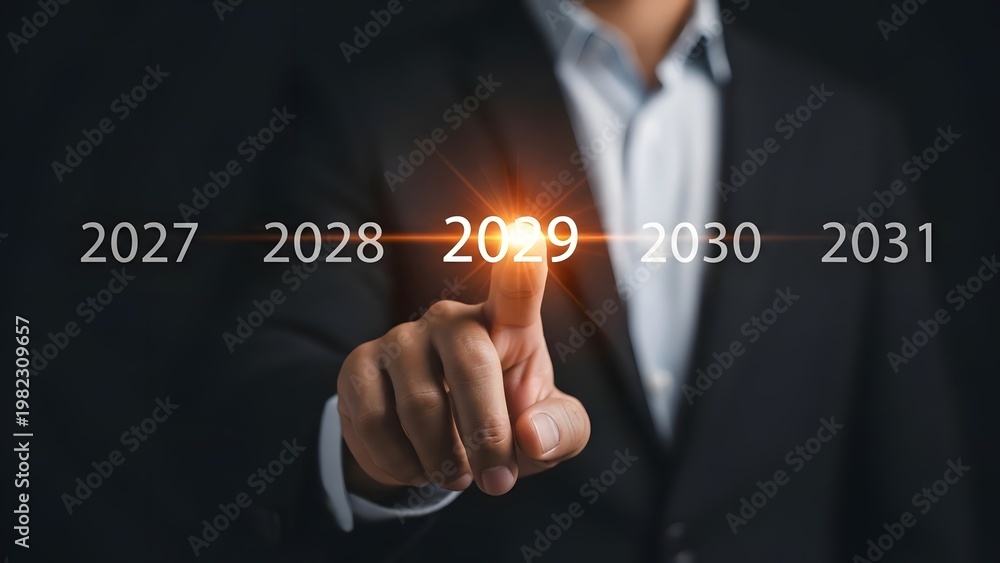 Obraz premium Businessman's hand points directly at the year 