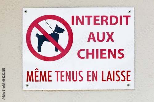 Dogs are prohibited even on a leash sign on a wall in French language