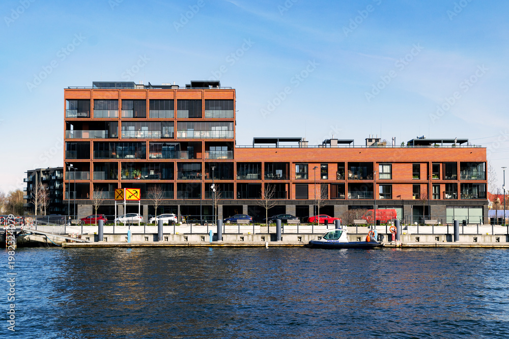 Obraz premium New block houses construction on the riverbank
