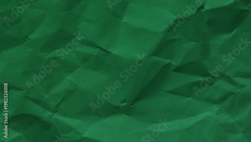 Rich green wrinkled paper texture in horizontal format, natural abstract backdrop