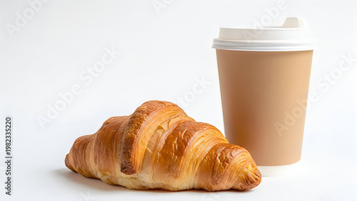 Golden croissant paired with a warm beverage in a disposable cup isolated on white background