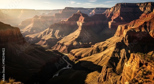 Vast canyon landscape with sunlight over rock formations in natural environment