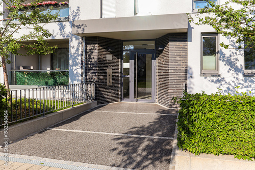 View to entrance door of a modern residential building with new apartments in the city