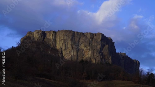 Time lapse video of the Pietra of Bismantova at sunset with a cloudy sky. Castelnuovo Monti, Reggio Emilia, Italy