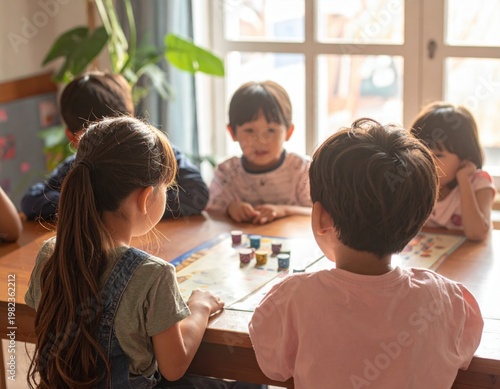 Children gathered around a table playing a board game together on a sunny day