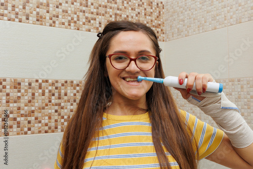 Young woman brushing teeth in bathroom