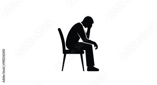 A man sits slumped in a chair expressing profound sadness silhouette
