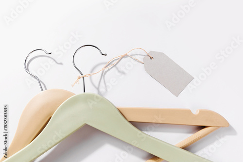 Canvastavla clothes hangers with blank tag and copy space on light background fashion retail