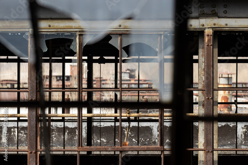 Layered Industrial Factory Windows with Rusted Steel Frames and Broken Glass
