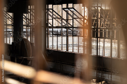 Golden Sunlight Streaming Through Rusted Industrial Factory Windows