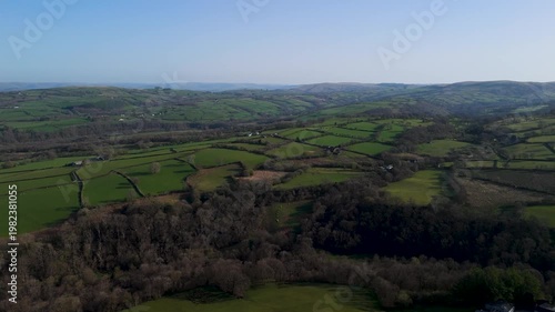 Aerial view of patchwork farmland and rolling green hills