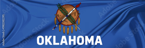 Oklahoma state flag with Osage warrior shield, olive branch and peace pipe on blue fabric, detailed patriotic banner