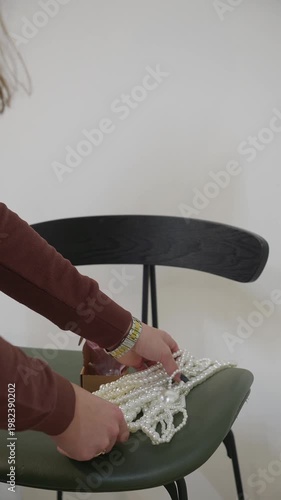 Vertical video of a pearl obese man lying on a chair.